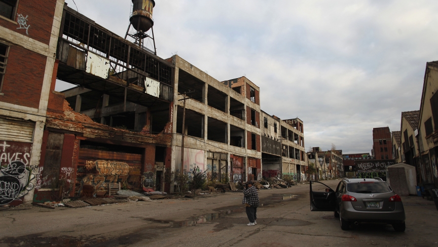 A man takes a picture of deteriorating buildings at the former Packard plant in Detroit, Michigan. A man takes a picture of deteriorating buildings at the former Packard plant in Detroit, Michigan.
